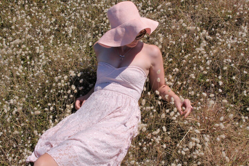 Fashion blogger in lace, wide brimmed hat, summer